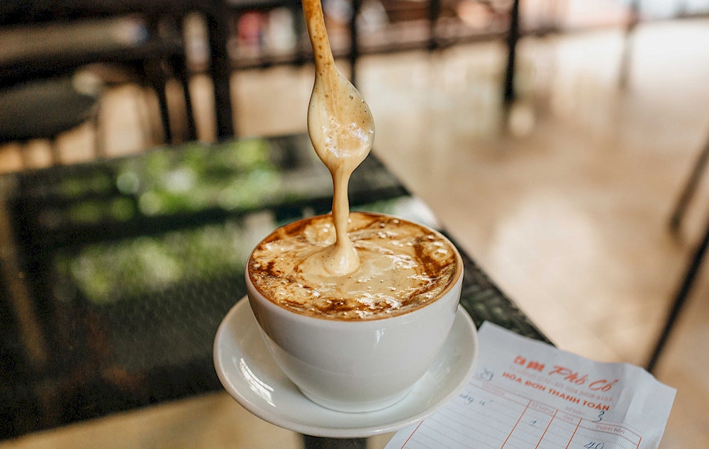 The golden, fluffy egg foam melts seamlessly into the deep, aromatic coffee